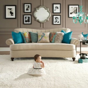 baby sitting on plush carpet in a living room | National Design Mart | Northeast Ohio