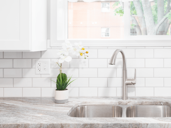 granite countertop with sink and white subway tile backsplash | National Design Mart | Northeast Ohio